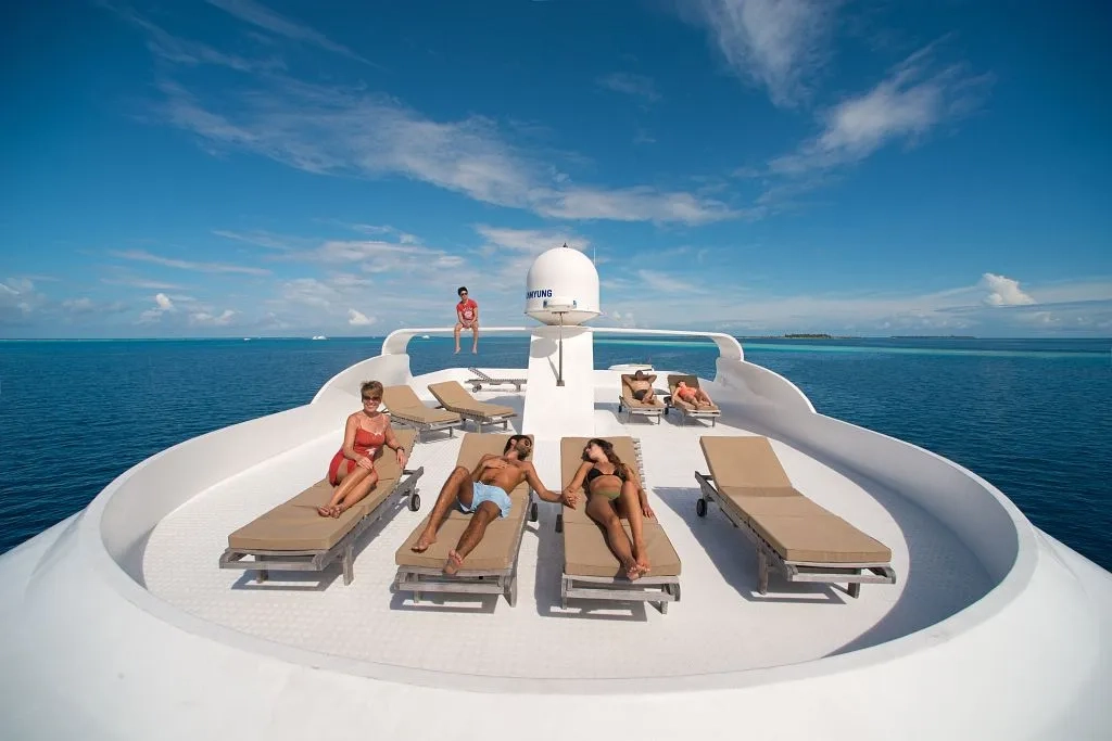 Guests relaxing on the Emperor Virgo sun deck in the Maldives